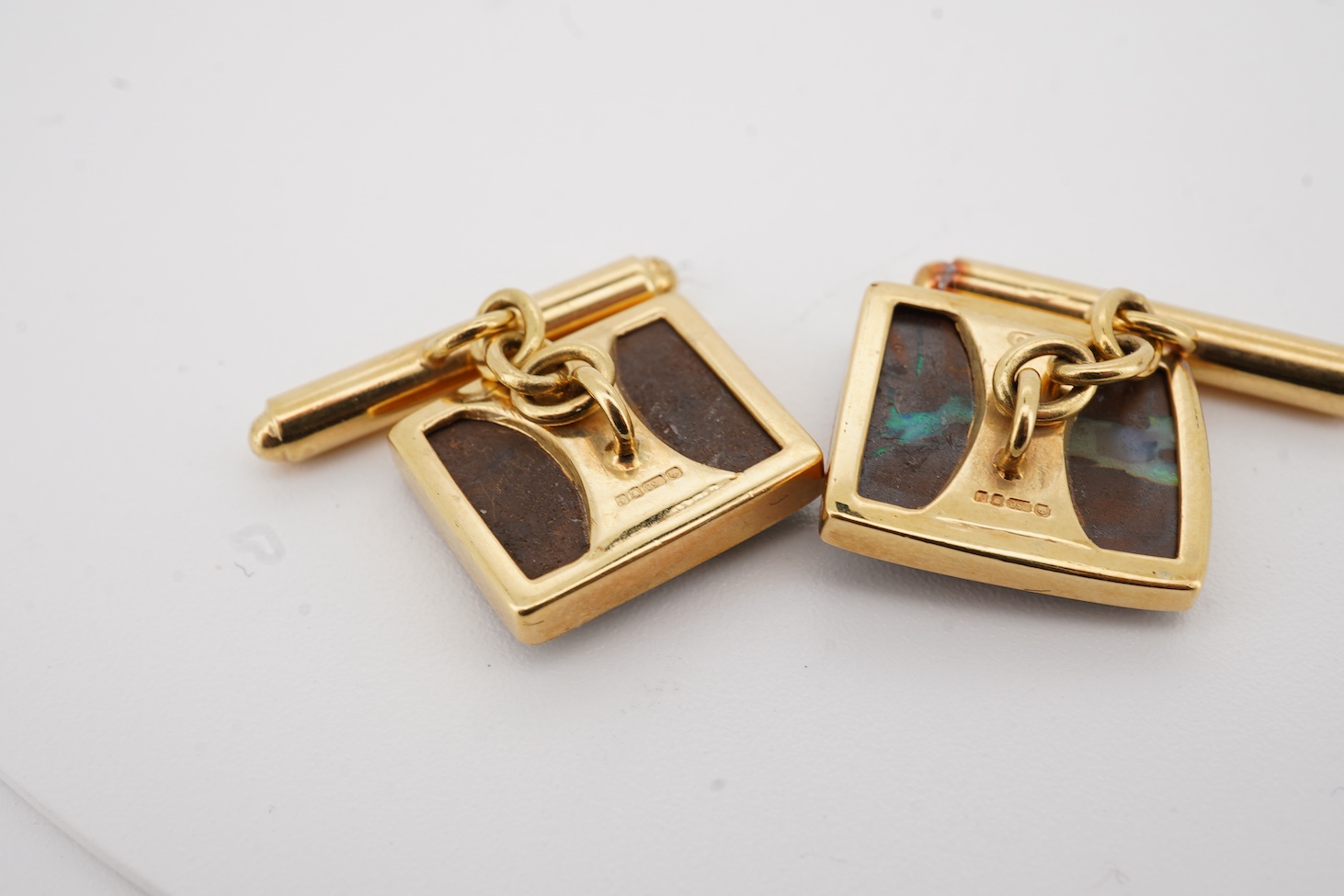 A modern pair of 18ct gold and opal set cufflinks by Geoffrey Turk Ltd, London, 13.5mm by 11mm, gross weight 7.8 grams, with original box.